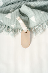 Fototapeta na wymiar Soft blue muslin blanket hanging on a baby's bed