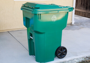 A clean green organic waste recycling plastic bin for residential use. Containers for yard, organic and wood waste.