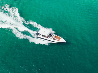 Aerial view of Speed boat at high speed in the aqua sea, Drone view.