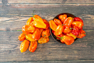 Scotch Bonnet hot spicy Peppers on wood Kitchen table