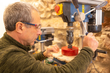 Carpenter polishing a piece of wood in studio