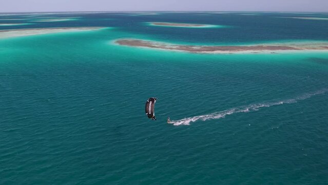Sailing across the surface of Caribbean ocean waters, Kite surfing 