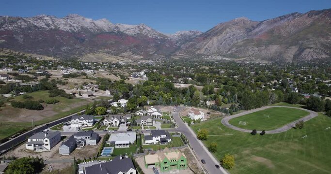 City of Alphine in Utah on a sunny autumn colors in the mountains. Drone dolley shot