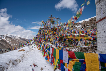 The beautiful views of Colorful Tibetan prayer flags on Khardung La or Khardung Pass - obrazy, fototapety, plakaty