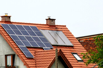 Historic farm house with modern solar panels on roof and wall