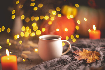 Autumn cozy composition. Tea in a mug, pumpkins and candles
