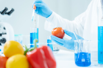 Scientist check chemical food residues in laboratory. Control experts inspect the concentration of...