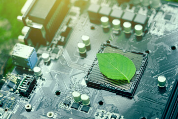 Green leaves inside a computer circuit board green technology and environmental technology Nature combined with digital technology. - 675150276