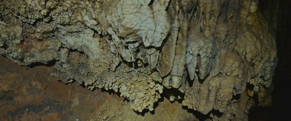 The cave excursion with natural landscape and ancient walls viewed in first person.The cave attraction landmark for tourists seeking adventure and unique travel experience. Pov view on rock formation