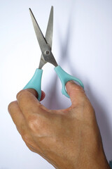 Woman's left hand holding scissors for grooming dogs on white background, Open blades, Accessories for cut, trim about Dog, Cat, Animal care in beauty salon concept, Close up shot