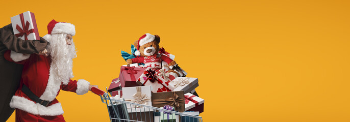 Santa Claus pushing a shopping cart full of gifts
