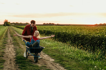 A couple sharing a moment of joy during a golden hour in the countryside