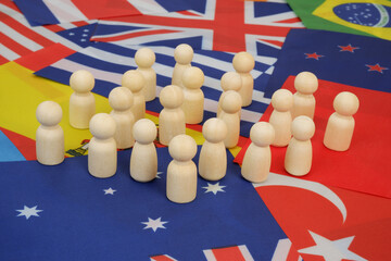 People figures on national flags background. International community concept.