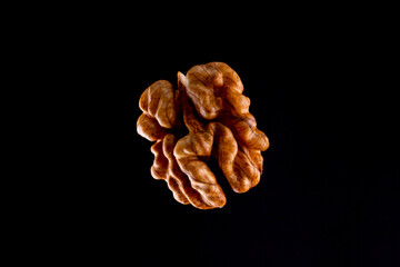 Walnuts on a black brown background.