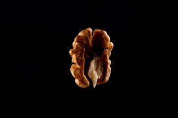 Walnuts on a black brown background.