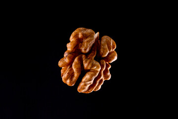 Walnuts on a black brown background.