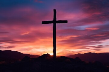 Silhouette of a cross on against a colorful sunset sky
