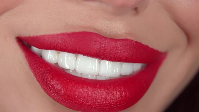 Close-up of perfect natural lip makeup of a beautiful female mouth with snow-white teeth. Healthy and white teeth concept. Dentistry and beauty.