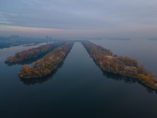 Obraz premium The rowing canal spit on Pobeda in the city of Dnieper from above. River View. Autumn colors. Drone photography.