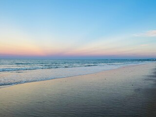 Pastel colors of the sea coast, sandy beach, purple sea horizon, tender natural gradient 