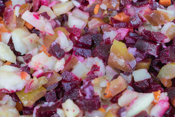 Vegetable salad with beets, carrots, onions and potatoes close up