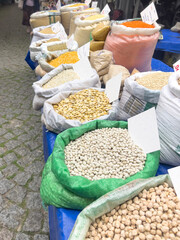 row of dried legumes and corns in sack bags