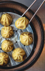 Fresh Dumplings with the Sticks in Traditional Chinese bamboo plate 