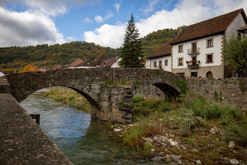 Old medieval stone bridge over the Andu&ntilde;a river in the typical Pyrenean village of Ochagav&iacute;a in Navarra, Spain with midday light