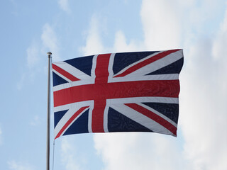 Union Jack flag of the United Kingdom over blue sky
