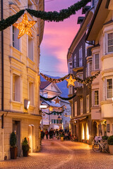 Streets of the center of Bressanone, illuminated by Christmas lights, Bolzano, Trentino Alto Adige, Italy - obrazy, fototapety, plakaty