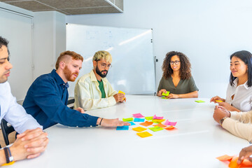 People using adhesive notes during a brainstorming in a meeting