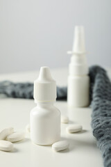 Near a medicine bottle with pills on a light background