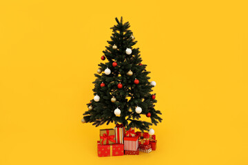 Decorated Christmas tree with gifts on a yellow background