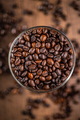 Roasted coffee beans in bowl. Top view.