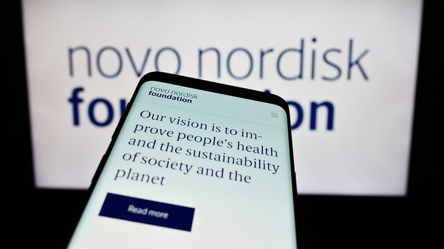 Stuttgart, Germany - 11-02-2023: Mobile phone with website of Danish organisation Novo Nordisk Foundation in front of logo. Focus on top-left of phone display.