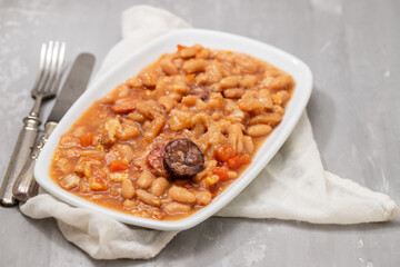 typical portuguese dish dobrada with beans in white dish