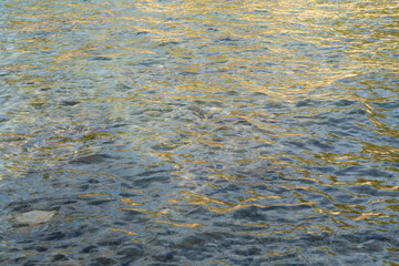 golden reflections of sunlight in clear sea water on the Mediterranean coast relaxing water surface
