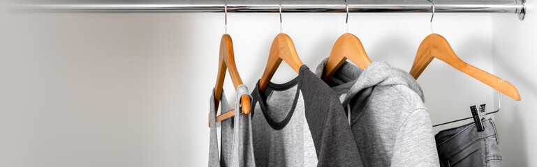 Gray clothes on hangers. Copy space.  Wide web site banner.