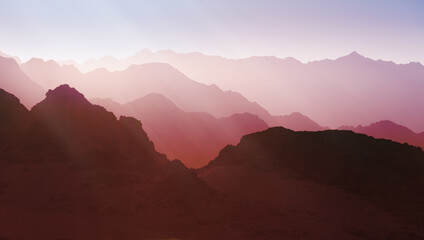 Mountainous terrain in vibrant pink shades. Abstract background. Futuristic landscape concept. © prystai