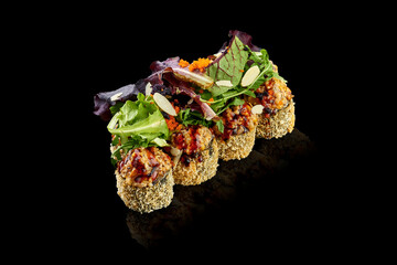 Baked sushi roll in tempura with salmon on a black background. Japanese food, photo for menu