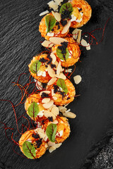 Set of baked sushi roll with shrimp and salmon on a black background. Japanese food, photo for menu