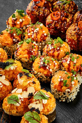 Set of baked sushi roll in tempura with salmon on a black background. Japanese food, photo for menu