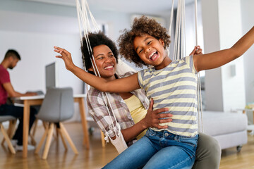 Family concept. Happy african american mother and daughter spendig fun time together at home