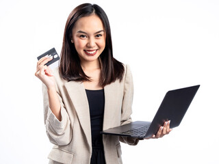 Naklejka premium A portrait of an Indonesian Asian woman wearing a cream-colored blazer, using a laptop, and showing a card. Isolated against a white background.