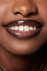 Cropped face photo. Extreme close up of beautiful woman smile with whitening healthy teeth. Perfect African-American female mouth.