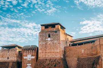 Castel Sismondo brick castle with tower on Piazza Malatesta square in old historical touristic city centre Rimini with blue sky background, Emilia-Romagna, Italy