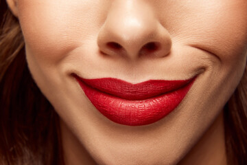 Fototapeta premium Smiling woman. Cropped close up portrait of beautiful young girl with pout lips. Lip matte lipstick. Skin care routine.