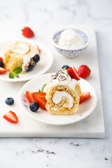 Homemade Swiss roll with whipped cream and berries