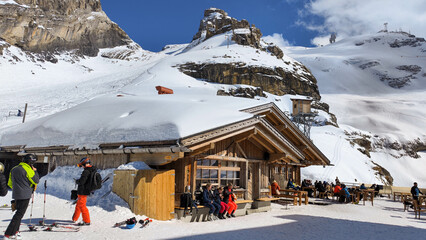 People eating on a ski restaurant over Engelberg on the Swiss alps
