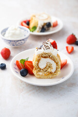 Homemade Swiss roll with whipped cream and berries